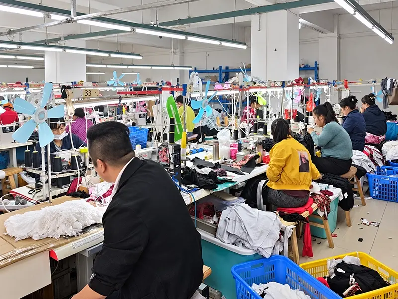 Garment production team working on a factory sewing line